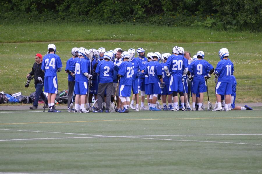 Boys Lacrosse huddles during their final game against Seattle Academy