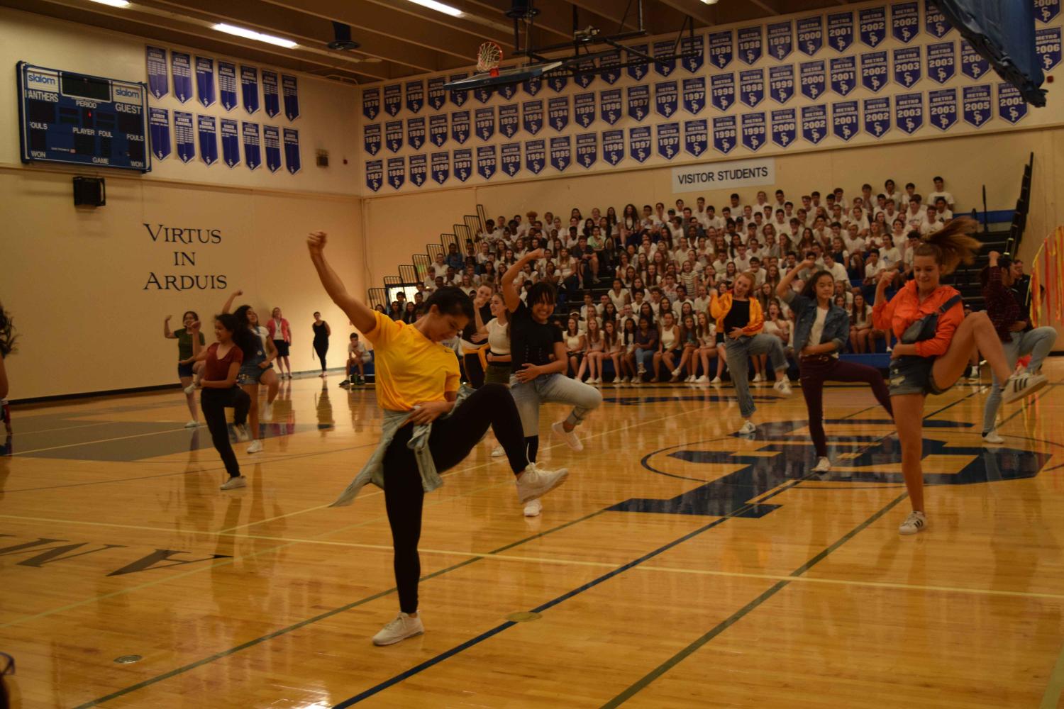 Pulse dances out their excitement st the back-to-school assembley. Leaders hope to build the team in numbers while keeping the unity of the group.
