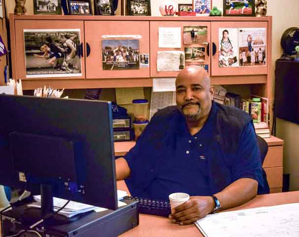 Director of Diversity Deino Scott in his office. Scott sees his role in the school as one to encourage discussion and understanding.