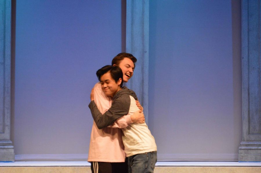 The Legally Blonde characters Nikos and Carlos embrace following the musical number Gay or European. The musical focuses on the celebration of love and culture of the LGBTQ+ community.
