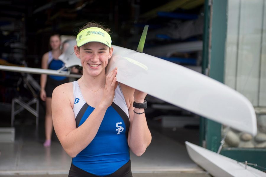 Emma+Conaty+carries+her+boat+from+the+boat+house.+Conaty%2C+who+only+started+rowing+two+years+ago%2C+will+be+heading+to+WSU+to+pursue+her+rowing+career.