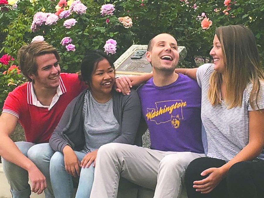 Charles Shafer, Caroline Cacabelos, Max Hanson, and Emma Johnson gather in front of the Alumni Service Corps house. This is the second year of the ASC program.