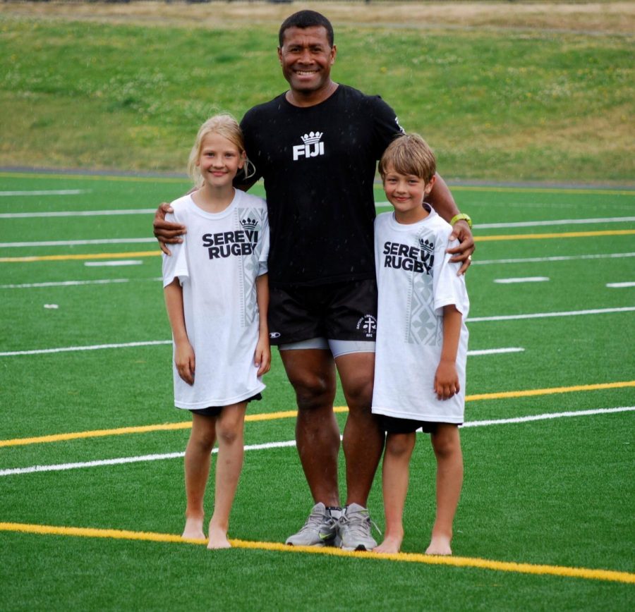 Chloe OMeara and her younger brother, Kieran, posing with a Serevi Rugby player.
