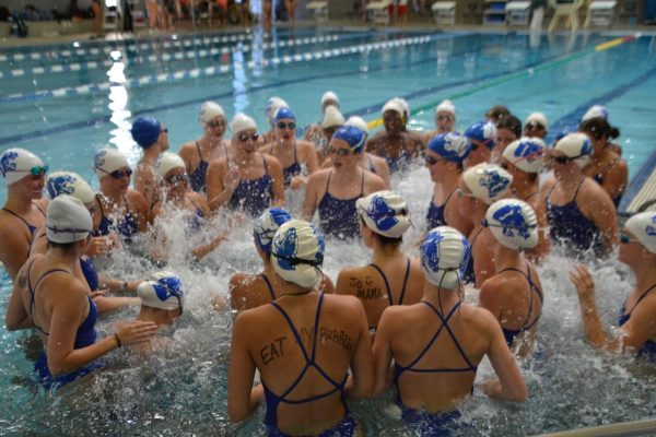 The team singing their swim chant before the start of the meet