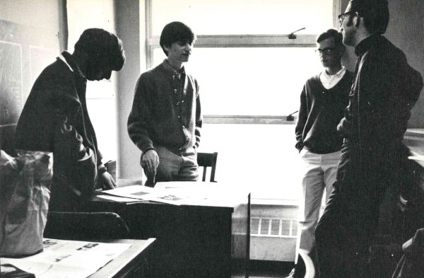 The 1969-70 Panther Editorial Staff discuss photography problems.