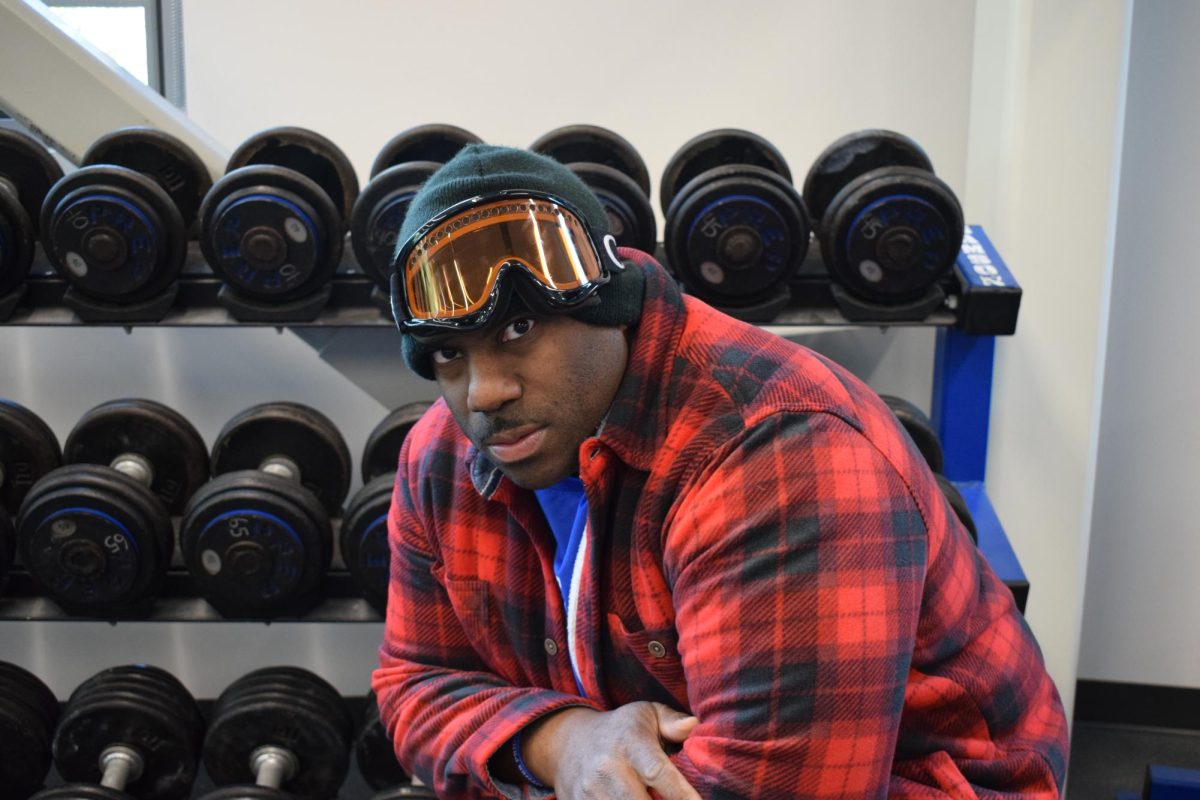 Coach AJ Middleton poses in the wright training room. Middleton has brought renewed enthusiasm and innovation to the weight training program this school year.