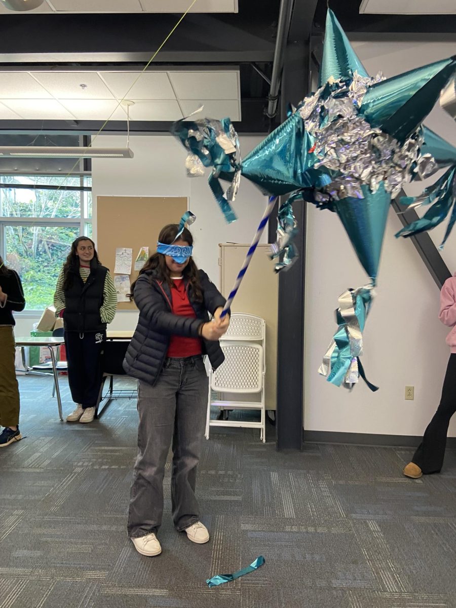 Latino Club members smash a pinata at a recent meeting.