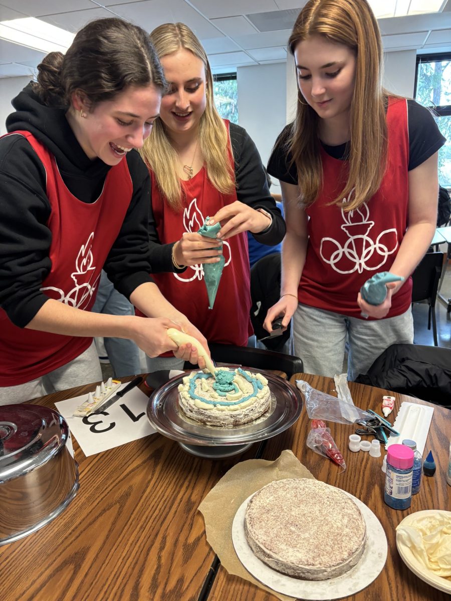 Juniors compete in Olympic Week's cake decorating event in the new reusable pinnies.