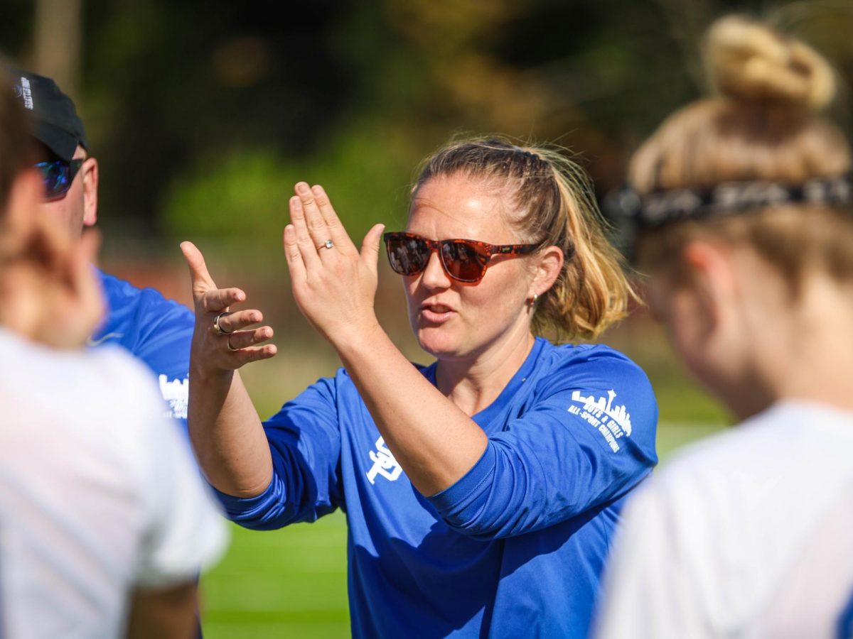 Girls Lacrosse Coach Ashley Hemmen on the sidelines. 