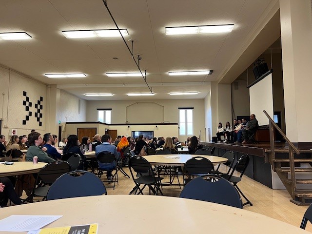 Cece Rocha '26 and Mia Lee '25 speak at an event at St. Joseph's school.