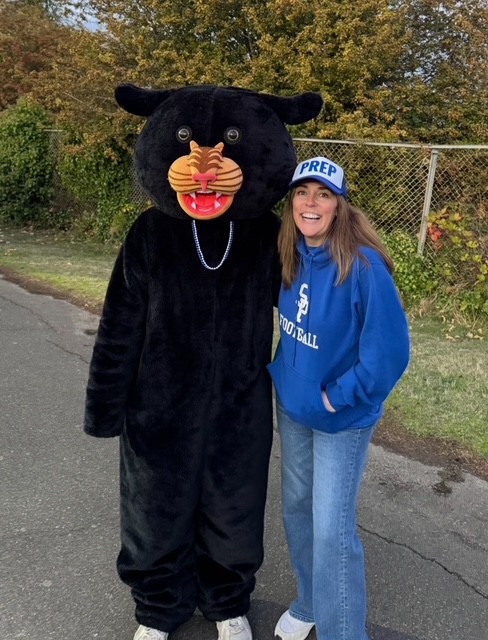 Alumni Laura Matter with our Panther Mascot at a Football Game.