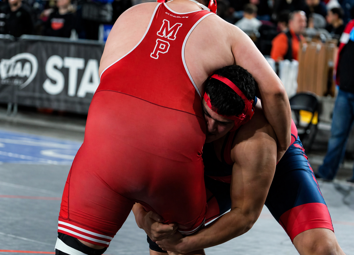 Stephen Kassab '26 takes down an opponent during a wrestling match.